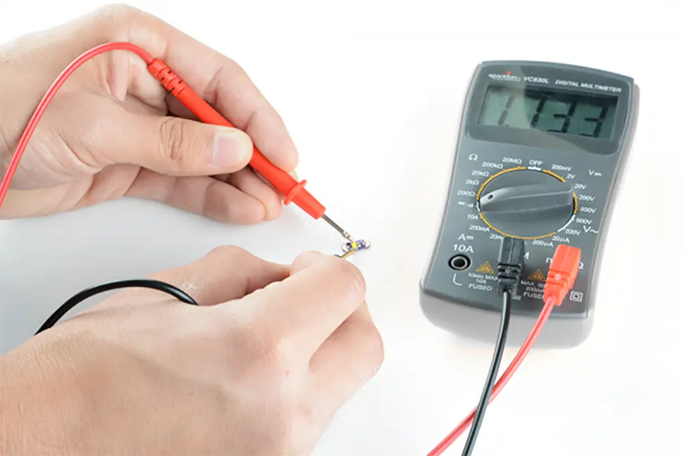 Technician using a multimeter on an LED strip